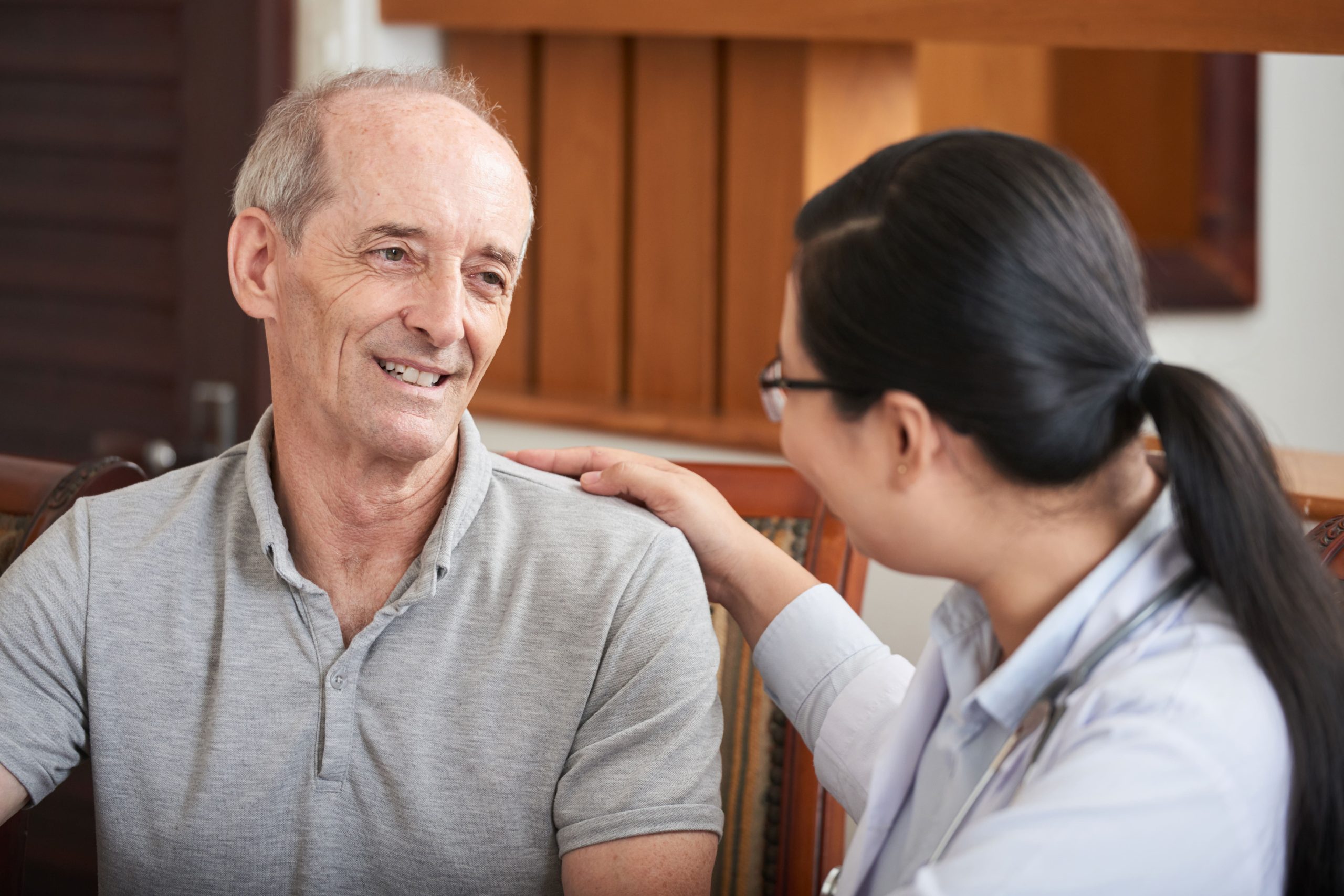 attentive doctor soothing senior patient 1 scaled