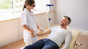 Healthcare professional administering IV therapy to a patient as part of an integrative cancer care treatment plan.