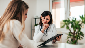 Patient consulting with a healthcare professional while discussing personalized treatment options at an integrative cancer center.